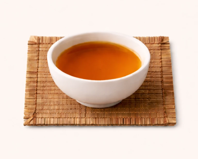 GABA tea leaves photographed close-up with a deep amber tone.