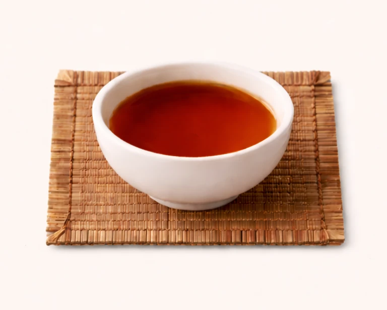 Red oolong tea leaves photographed close-up with a richer warm tone.